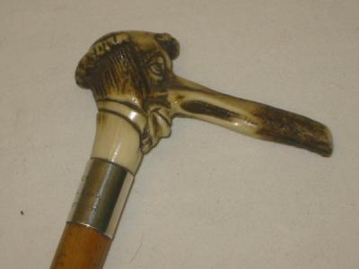 Appraisal: AN EDWARDIAN SILVER MOUNTED CANE the antler top carved as