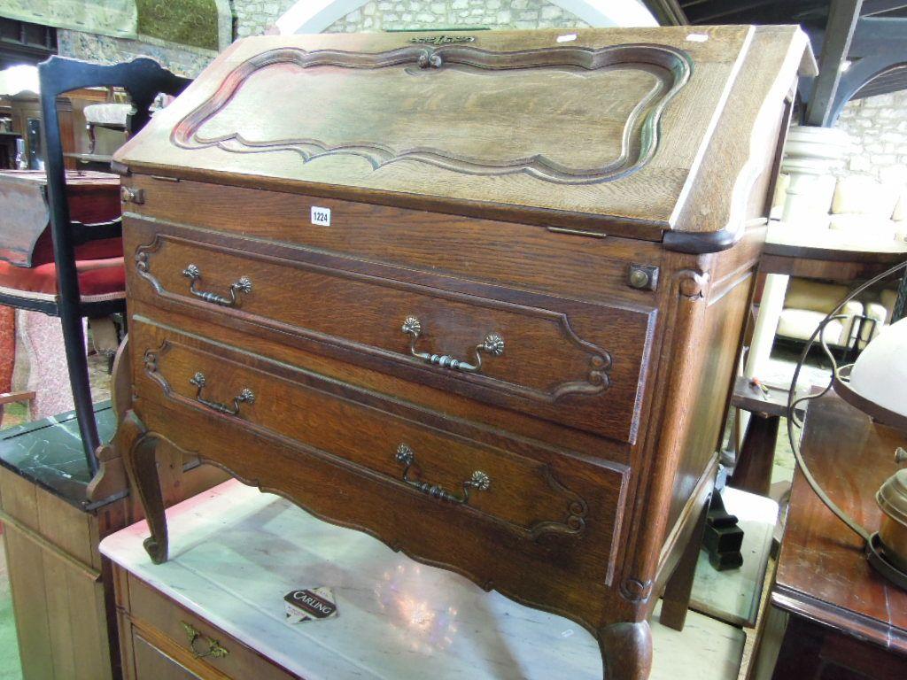 Appraisal: A French oak bureau the panelled fall front enclosing a