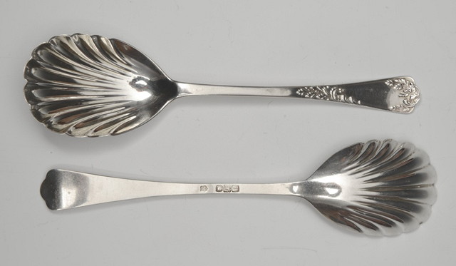 Appraisal: A PAIR OF SILVER FRUIT SERVING SPOONS with shell bowls