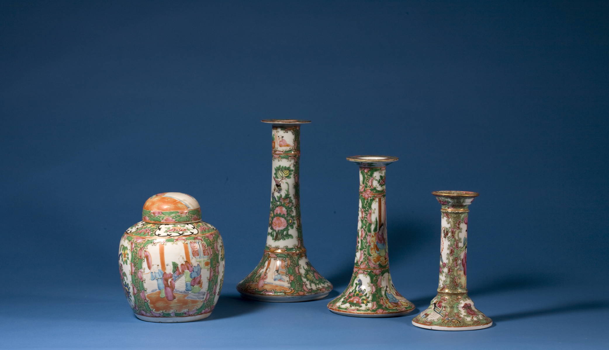 Appraisal: THREE GRADUATED ROSE MEDALLION CANDLESTICKS AND A GINGER JAR Height