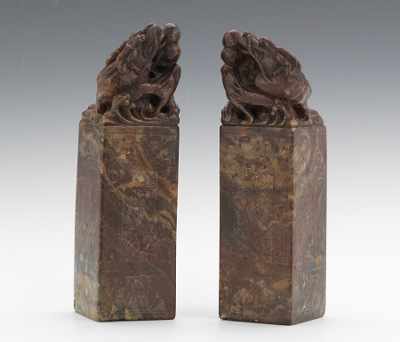 Appraisal: A Pair of Carved Hardstone Seals Carved pinkish-brown hardstone seals