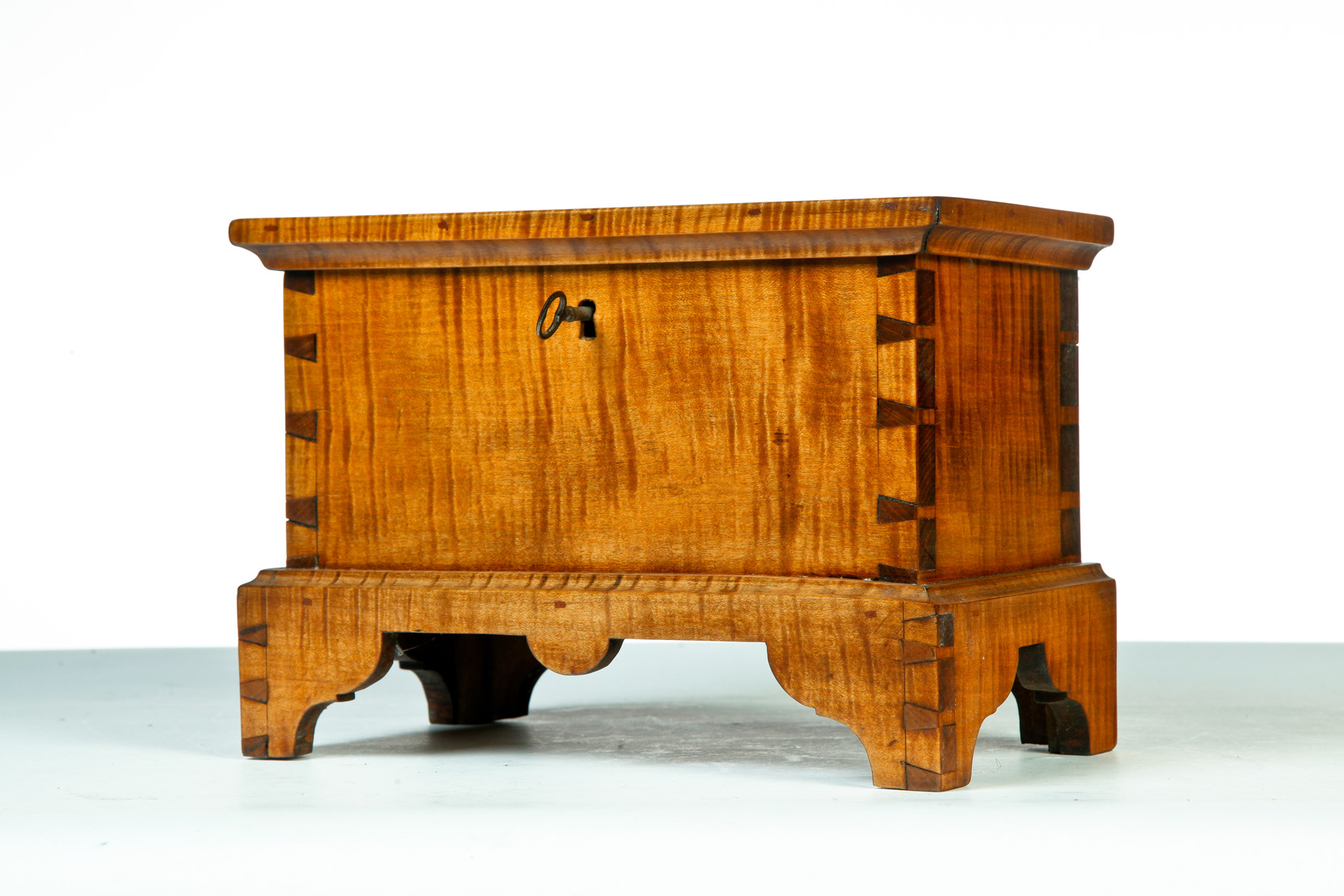 Appraisal: CHIPPENDALE-STYLE MINIATURE BLANKET CHEST American nd half- th century Tiger