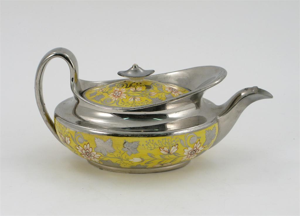 Appraisal: A silver and yellow lustre teapot and cover