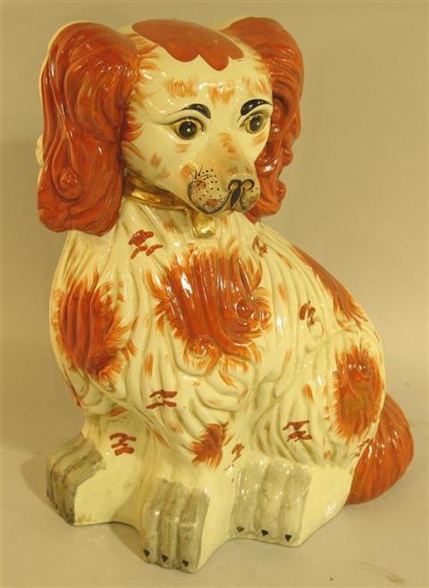 Appraisal: LARGE STAFFORDSHIRE STYLE MODEL OF A SPANIEL The amusing hound