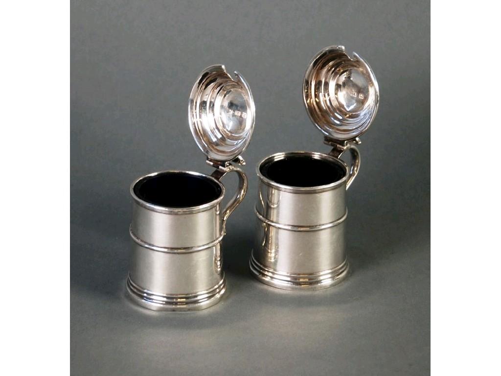 Appraisal: PAIR OF GEORGE V SILVER MUSTARD RECEIVERS of Georgian lidded