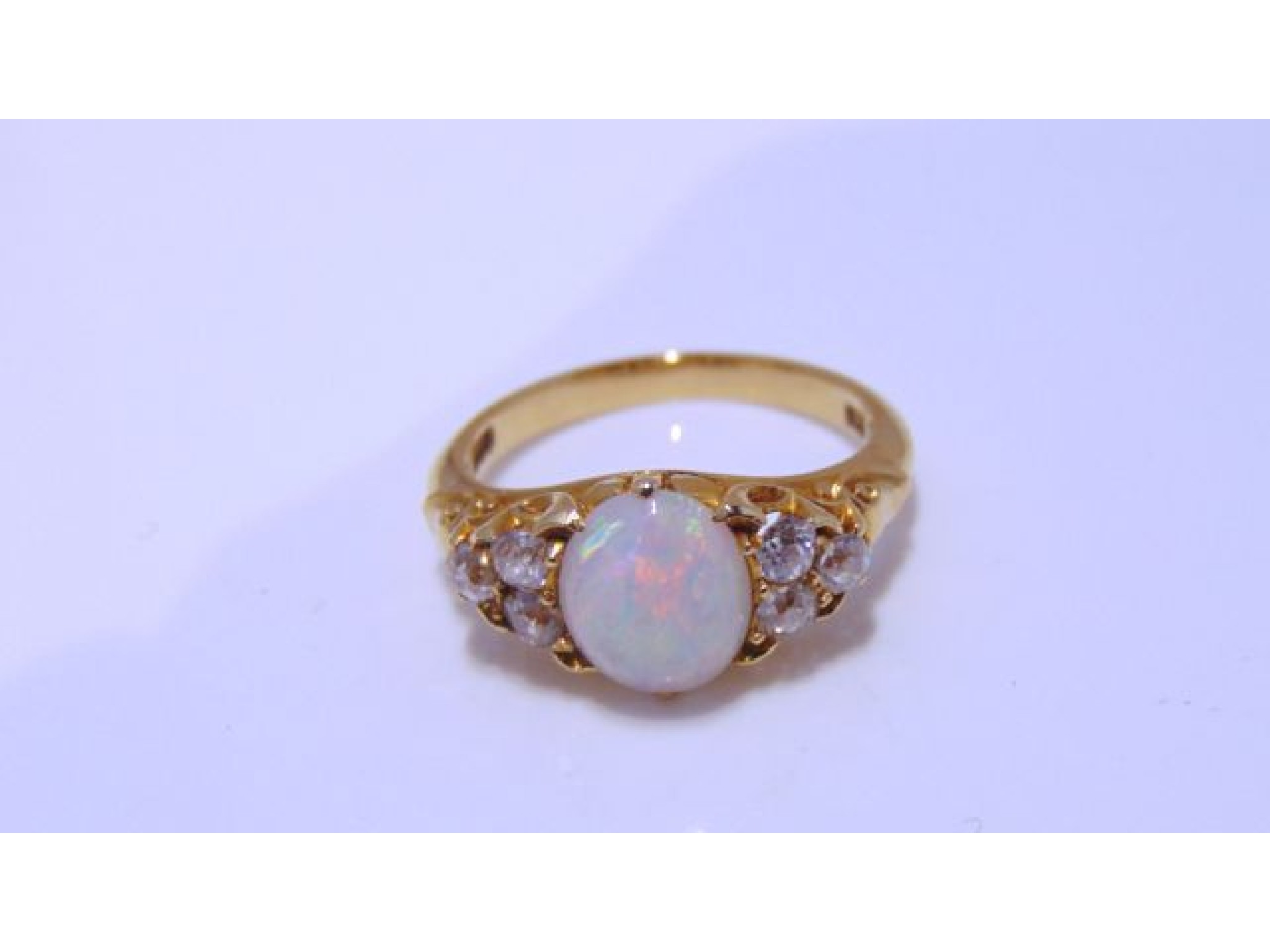 Appraisal: An Edwardian style opal and diamond ring centred with an