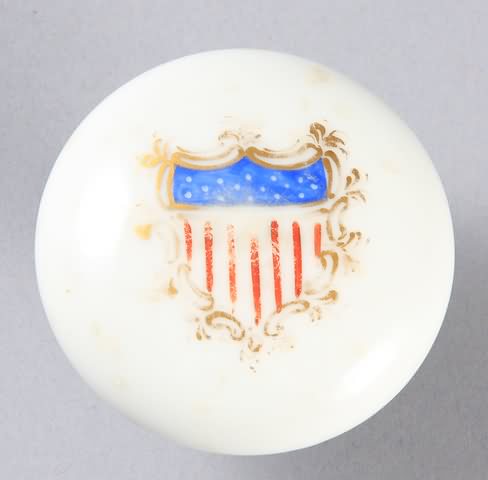 Appraisal: White porcelain doorknob with paint decorated shield sold with key