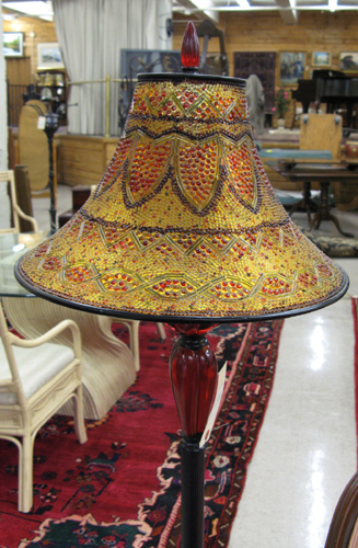 Appraisal: BRONZED METAL AND RED CHERRY RESIN FLOOR LAMP the bronzed