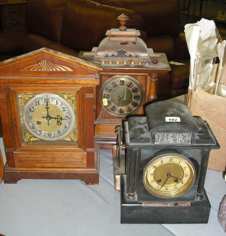 Appraisal: French slate and marble two train mantel clock within an