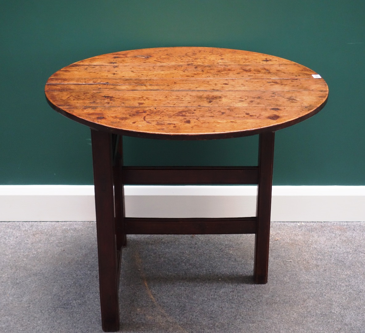 Appraisal: An th century fruitwood folding table the circular plank top