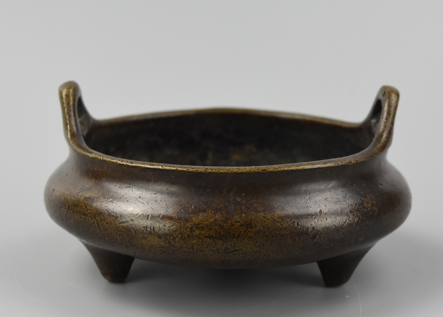 Appraisal: CHINESE DUELING DRAGON TRIPOD CENSER TH C A Chinese tripod