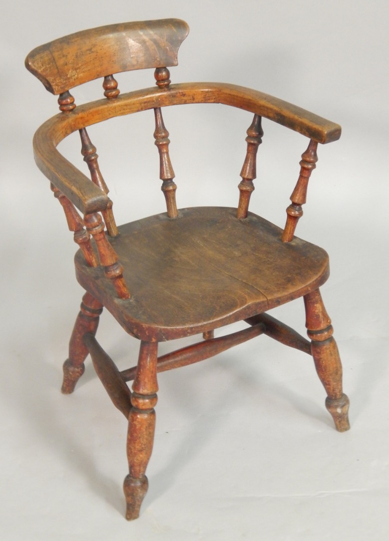 Appraisal: A thC ash and elm child's captains type chair with