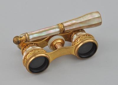 Appraisal: A Pair of Mother of Pearl Clad Opera Glasses Marked