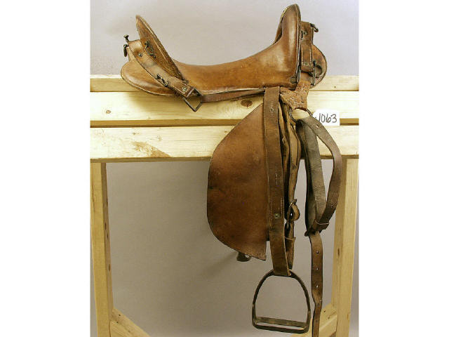 Appraisal: McCellan service saddle complete with fenders and stirrups seat fenders