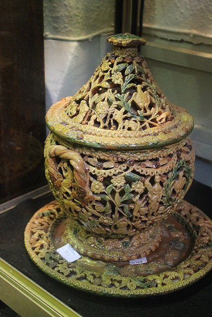 Appraisal: A PORTUGUESE POTTERY RETICULATED BOWL cover and stand with rope-twist