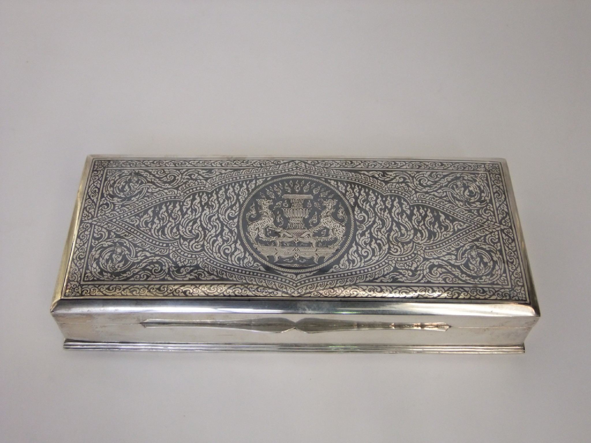 Appraisal: A Thai sterling silver and niello enamelled cigar box of