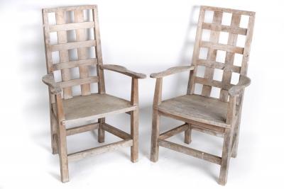 Appraisal: A pair of yew wood garden armchairs with slatted backs