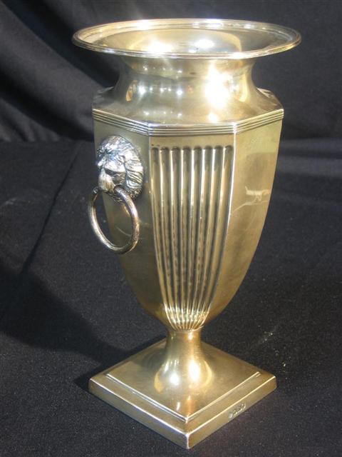 Appraisal: ENGLISH SILVER VASE Octagonal-paneled baluster shape the shoulders with lion