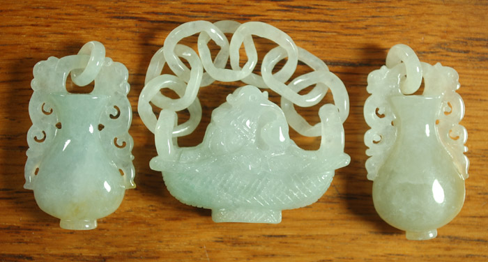 Appraisal: LIGHT GREEN CARVED JADE BASKET WITH TWO URNS heights from