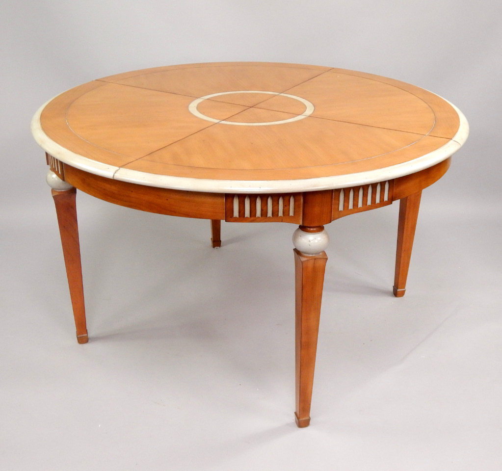 Appraisal: A modern cherrywood extending dining table of rounded square design