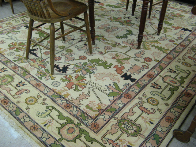 Appraisal: HAND KNOTTED ORIENTAL CARPET Pakistani-Persian stylized foliate design on khaki