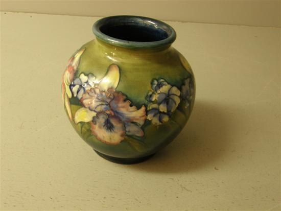 Appraisal: Moorcroft green glazed vase decorated with pansies and lilies impressed