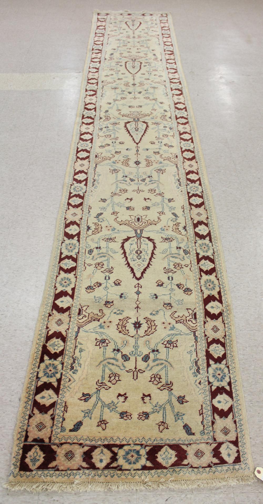 Appraisal: HAND KNOTTED ORIENTAL CORRIDOR RUG Pakistani-Persian overall floral design on