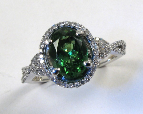 Appraisal: TSAVORITE GARNET AND DIAMOND RING with appraisal The k white