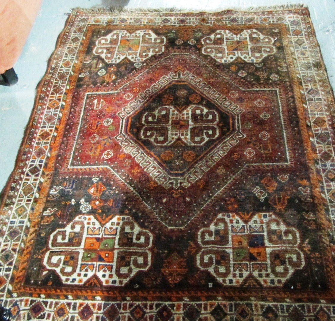 Appraisal: A Shiraz rug Persian the shaped madder field with five