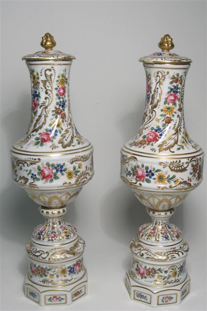 Appraisal: Pair of French porcelain lidded urns with floral decoration th