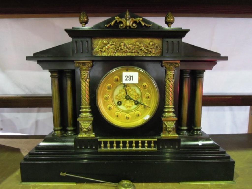 Appraisal: A Victorian black slate and brass overlaid classical mantle clock