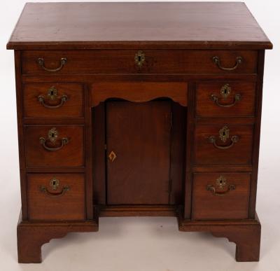 Appraisal: A Georgian mahogany kneehole desk with eight drawers and kneehole