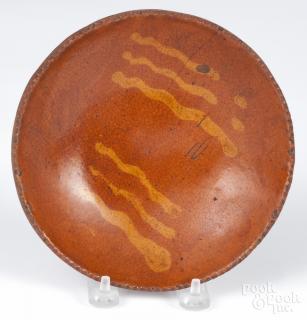 Appraisal: Pennsylvania redware plate th c with slip decoration '' dia