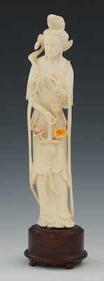 Appraisal: Carved Ivory Attendant Holding A Flower Basket Standing figure holding