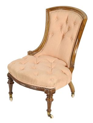 Appraisal: A Victorian carved walnut nursing chair with button upholstered back