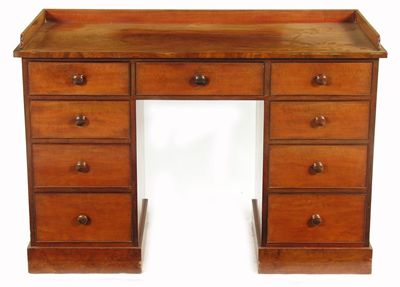 Appraisal: A Victorian mahogany kneehole dressing table with a three quarter