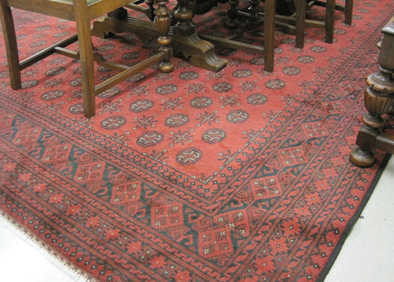 Appraisal: HAND KNOTTED ORIENTAL CARPET Afghan Turkoman the rectangular red field