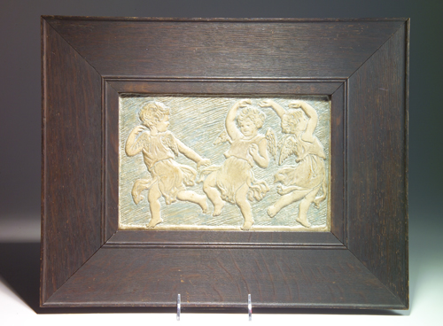 Appraisal: BATCHELDER Horizontal panel modeled with three dancing putti against blue