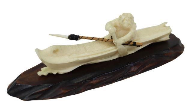 Appraisal: Inuit carved walrus bone kayak with harpooner and harpoon set