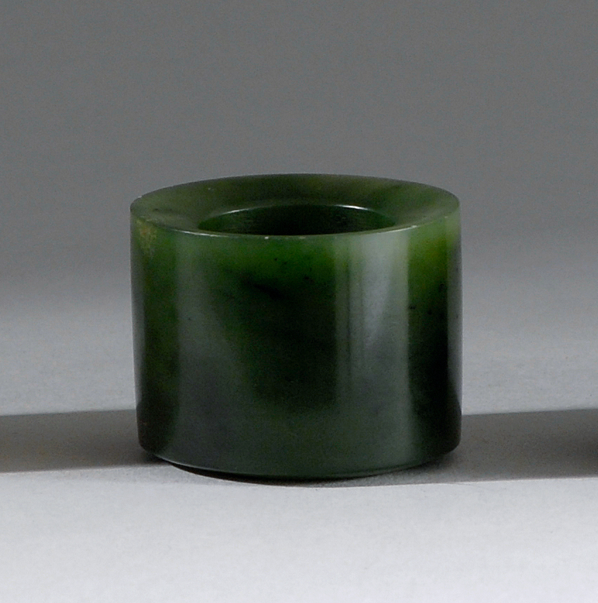 Appraisal: GREEN INK JADE ARCHER'S RING th CenturyIn cylinder form From