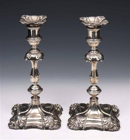 Appraisal: A PAIR OF EDWARDIAN SILVER CANDLESTICKS on shaped square bases