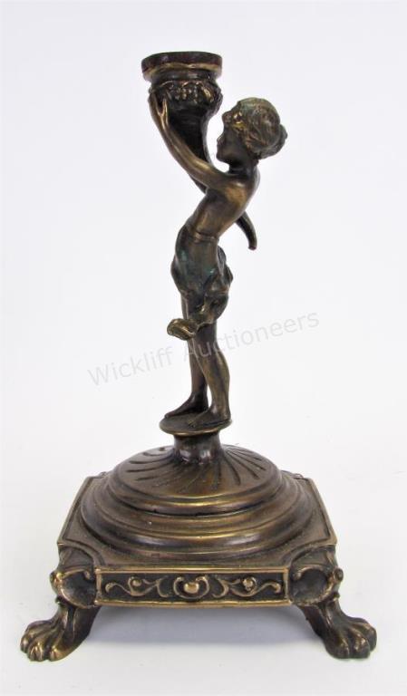 Appraisal: Bronze Figural Candlestick depicting a boy holding up a cornucopia