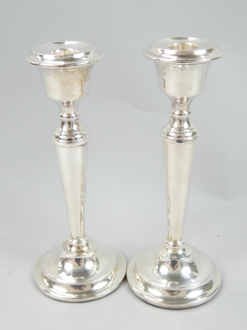 Appraisal: A pair of Elizabeth II silver candlesticks each with compressed