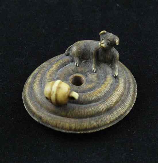 Appraisal: A Meiji period stained ivory netsuke carved as a puppy