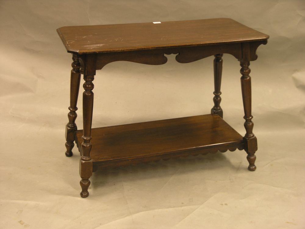 Appraisal: An Edwardian walnut side table on turned legs with undertier