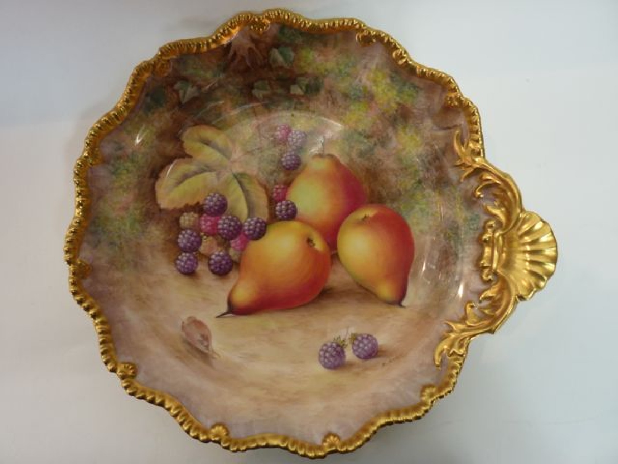 Appraisal: A Royal Worcester dish of circular form with gilded shell