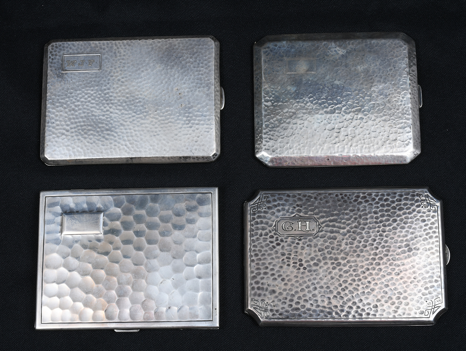 Appraisal: HAMMERED SILVER CIGARETTE CASES Comprising - Trueart case - Napier