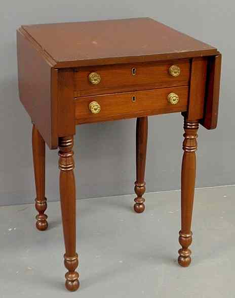 Appraisal: Sheraton mahogany two-drawer drop-leaf stand c with turned legs h