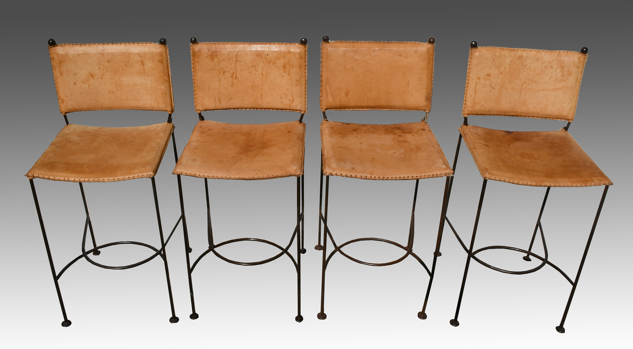 Appraisal: LEATHER IRON STOOLS - Wrought iron stools having leather upholstery