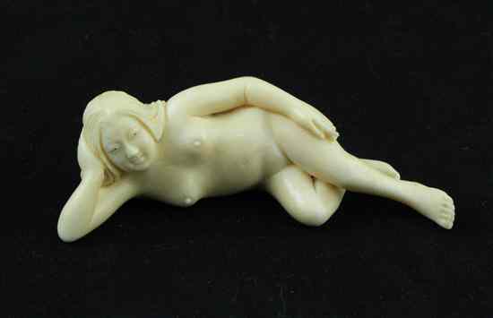 Appraisal: A Meiji period ivory okimono carved as a reclining nude